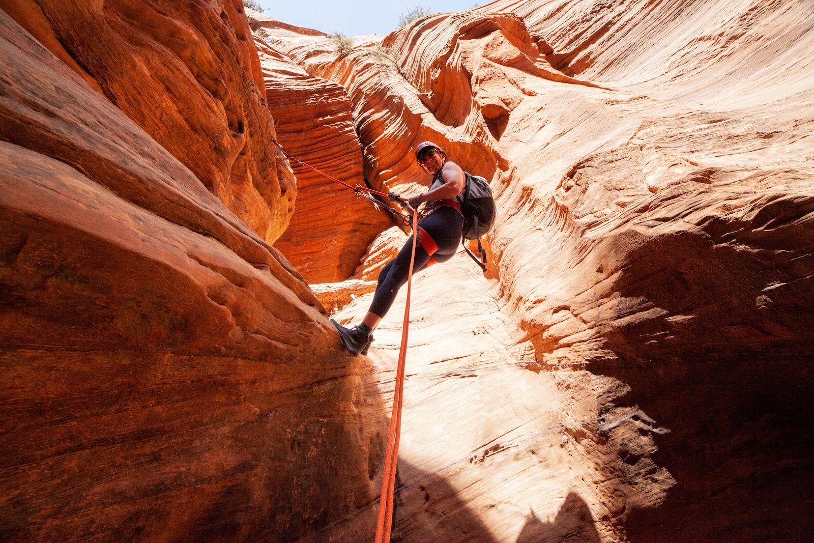 Woman rapelling down Rock canyon near Zion.
