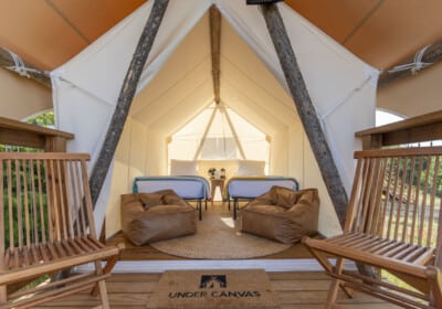 interior kids tent with two twin beds bean bags and chairs on the deck
