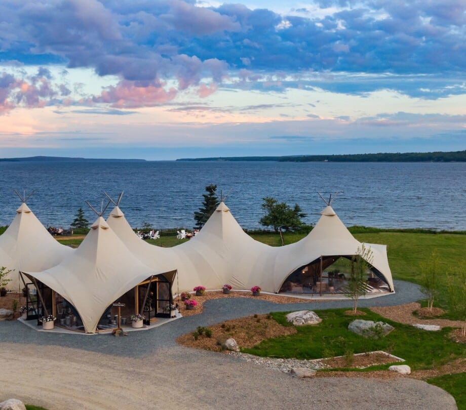 Lobby tent at Under Canvas Acadia with water in the background.