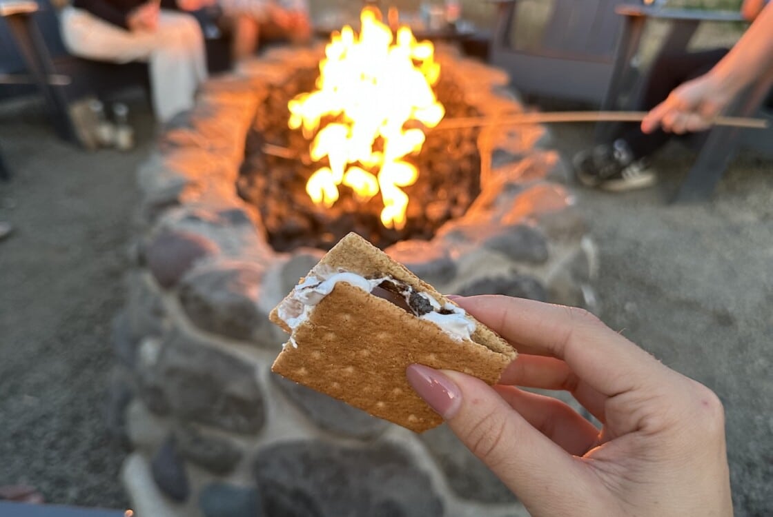 Group eating s'mores around a campfire.