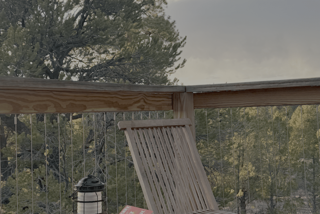 Book and lantern sitting on a private tent deck at Under Canvas Santa Fe.